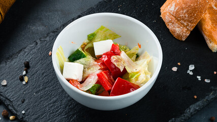 Fresh salad of fresh tomato, sweet pepper, lettuce, red onion and feta cheese.