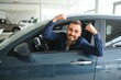 © Serhii - Man customer male buyer client chooses auto wants to buy new automobile