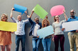 © TamJam/peopleimages.com - Business people, portrait and speech bubbles with team for social media, comment or feedback on a gray studio background. Group of employees with smile or shape for review, message or communication