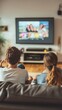 © Sasa Visual - A family sits closely together in their living room, watching a movie on a large screen while enjoying each other's company
