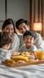 © Sasa Visual - A cheerful Asian family shares a delightful room service breakfast in their hotel, creating joyful memories together