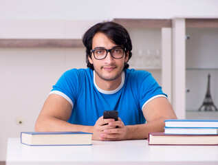 Poster - Young handsome student studying at home