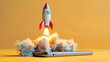 © chocoloki - rocket taking off from a laptop, yellow background with copy space