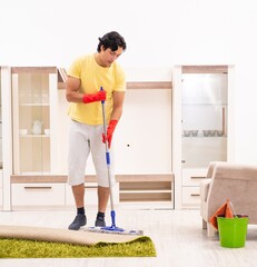 Wall Mural - Young handsome man doing housework