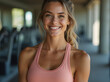 © FHL - A fit, smiling woman in a bright workout tank top enjoys a post-workout glow, symbolizing health, fitness, and an active lifestyle in a modern, gym setting.