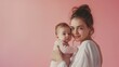 © WiFi - A woman is holding a baby, giving a sense of a mother's love for her child, against a pink background.