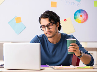 Wall Mural - Young handsome designer working at the project