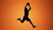 © Anuyj - Basketball player silhouette jumping, orange background