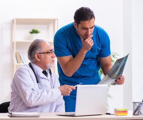 Wall Mural - Two male doctors working in the clinic