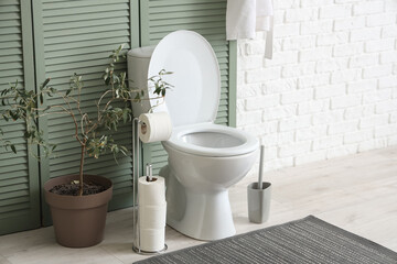 Sticker - Toilet bowl, paper holder and houseplant in restroom