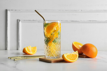 Wall Mural - Glass of fresh lemonade with orange and mint on white background