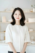 © sujeong - Smiling Young Woman Wearing Apron in a Bright Modern Kitchen