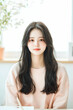 © sujeong - Portrait of a Smiling Young Professional Woman at Work in an Office Environment