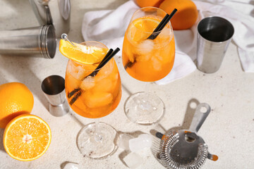 Wall Mural - Glasses of Aperol spritz cocktail with oranges on white background