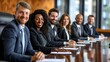 © nilanka - A diverse group of business professionals in formal attire smiles during a corporate board meeting