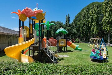 Kid Playgrounds on green grass field in garden and blue sky