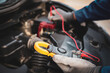 © Jintana - Close-up hand auto mechanic using meter to check car battery fail problem for service or change repairing and fix car and maintenance servicing.