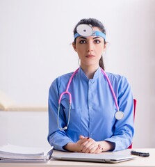 Wall Mural - Young female doctor working in the clinic