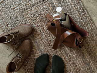 Wall Mural - Women's feet in green socks, suede oxford boots, tote bag, umbrella on the jute carpet in the hallway