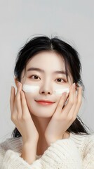 Beautiful Asian Woman Applying Face Cream