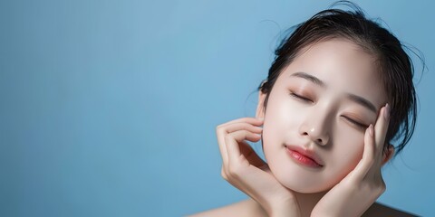 Wall Mural - Beautiful Woman with Closed Eyes Posing in Blue Background