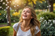 © Wee Ha - Portrait of a young woman beaming with joy, her eyes sparkling with joy seeing the sprinkling of flowers falling in the garden
