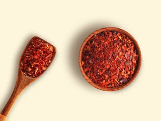 Red Pepper in wooden bowl with spoon isolated on white background , top view , flat lay.