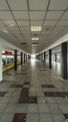 Canvas Print - Abandoned Interior of a Mall with Checkered Tile Floor