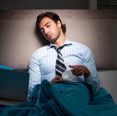 Sticker - Tired businessman working overtime at home at night