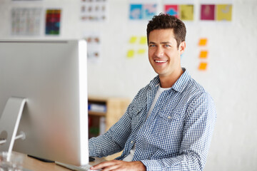 Wall Mural - Graphic designer, man and portrait in office with computer for process, smile and problem solving at company. Person, employee and happy with pc for project management at creative agency in Spain