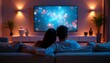 © abu - A lovely couple cuddle on an elegant sofa, watching TV in a softly lit, luxurious home.