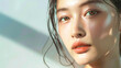 © Alina Tymofieieva - Beauty portrait of an Asian woman with clear skin on a light background. Beautiful model posing indoors.