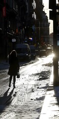 Poster - Woman Walking on Snowy Street in City