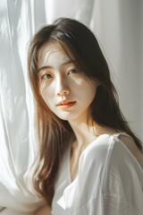 Wall Mural - Asian Woman Posing With Curtain In Sunlight