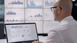 © CALMANDRELAX STUDIO - Business analyst analyzing data on laptop with multiple screens displaying graphs and charts in a modern workspace.