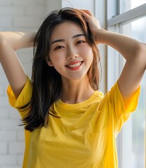 Wall Mural - Smiling Asian Woman with Long Black Hair Wearing Yellow T Shirt by Window