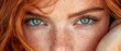 © Jevjenijs - A tight shot of a woman's face, adorned with an array of freckles, framing her expressive green eyes