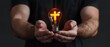 © Jevjenijs - A man holds a light bulb with a cross in its center, while also carrying an additional light bulb in his hands