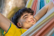 © carballo - young man in summer sleeping in hammock outdoors