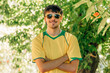 © carballo - portrait of smiling young man in sunglasses and yellow t-shirt in summer
