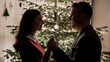 © Grafigator - photo of a couple holding hands in front of a Christmas tree