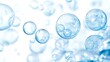 © Darunee - Bright and airy scene of clear blue bubbles varying in size, floating across a white background with depth and transparency