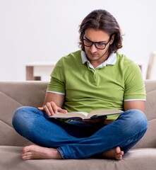 Young male student preparing for exams at home