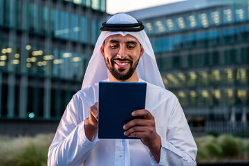 Arab middle-eastern man wearing emirati kandora traditional clothing in the city