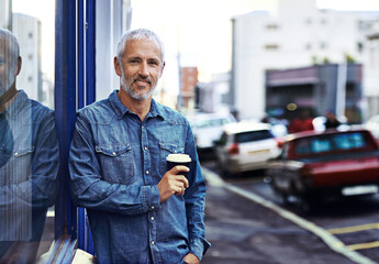 Poster - Mature man, portrait and coffee in city for lunch break, travel and relax in morning with by window. Cafe owner, happy and cup of latte by sidewalk for small business, startup and welcome in New York