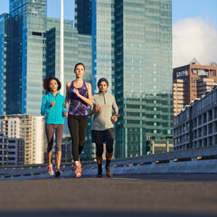 Poster - Urban, road and people running together for fitness, morning training or commitment to healthy body. City, exercise and group of friends on street for workout, outdoor challenge or sports performance