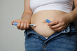 © millaf - Woman injecting Semaglutide Ozempic injection control blood sugar levels