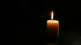 Burning candle on dark background, space for text. Memory day