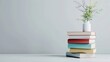© Rungthiwa - Stack of colorful books with vase of flowers