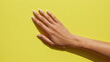 © Anjum Ilyas - Right hand on yellow background